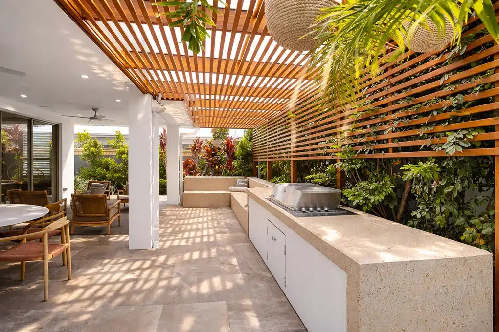 Luxury backyard alfresco entertaining area featuring a timber batten pergola ceiling