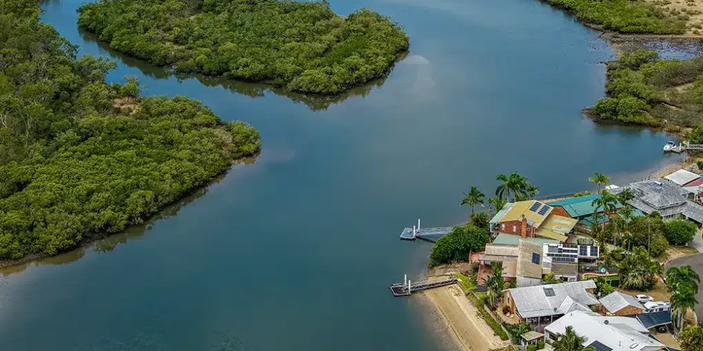 Drone photography Sunshine Coast — aerial view of river inlet mangroves and waterfront homes by Studio Rob