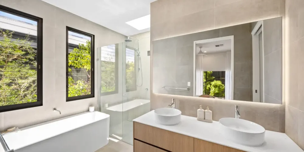 Real estate photography Sunshine Coast — luxury master ensuite with double vanity timber cabinetry and large mirror by Studio Rob