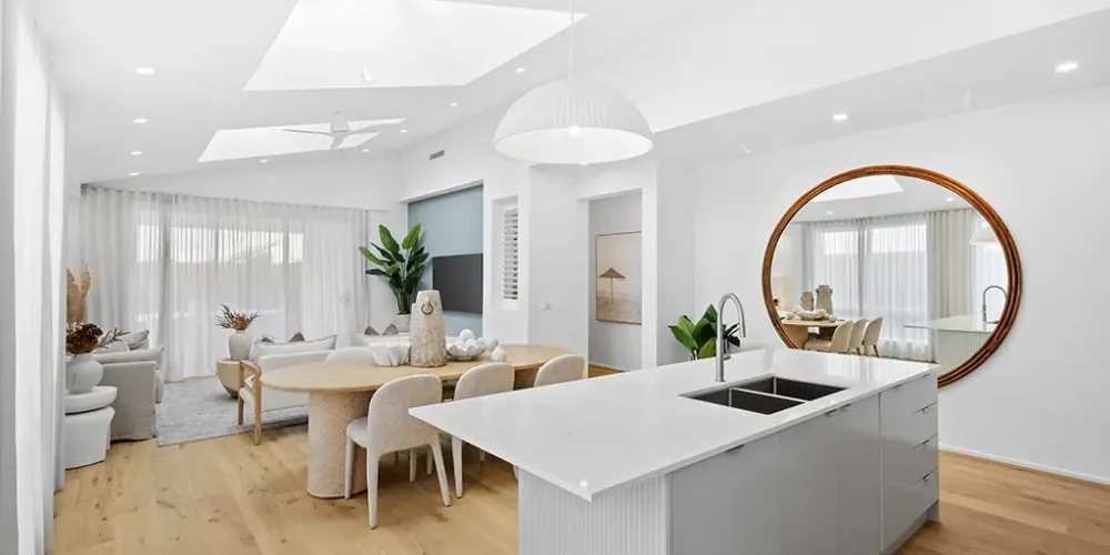 Real estate photography Sunshine Coast — open plan kitchen and living area with vaulted ceiling and round mirror by Studio Rob
